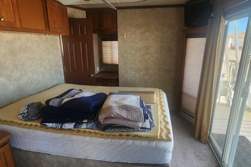 Slide: The Image of Interior of 2010 Destination Yachts Starchaser, featuring a cozy bedroom with folded linens. - 5