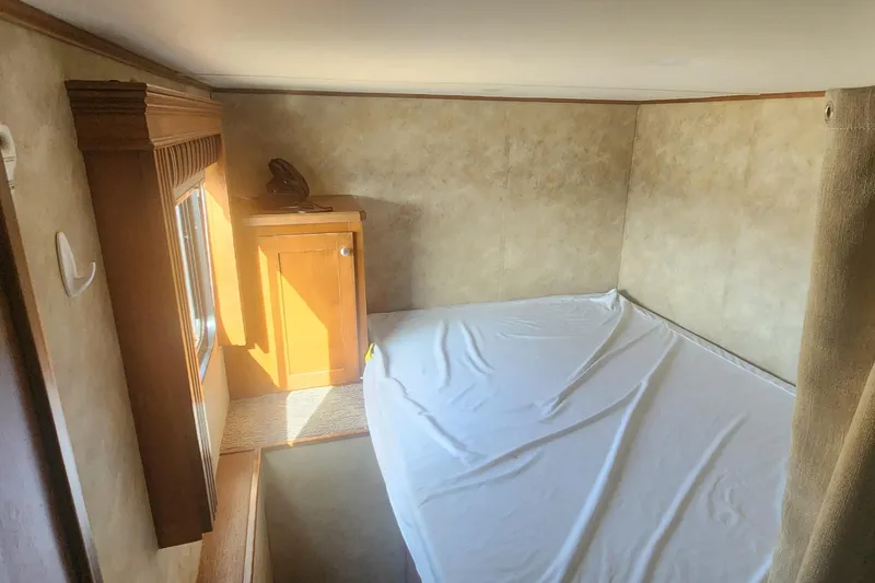 Slide: The Image of Wood-paneled interior with built-in TV and shelf in 2005 Sumerset Star Chaser. - 10