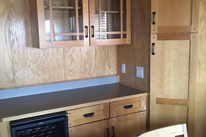 Slide: The Image of Wooden kitchen interior of 2005 Sumerset Star Chaser, featuring cabinets and countertop. - 15