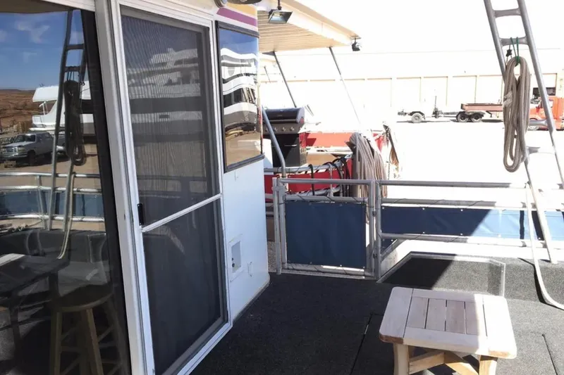 Slide: The Image of 2005 Sumerset Star Chaser houseboat deck with outdoor seating and equipment. - 17