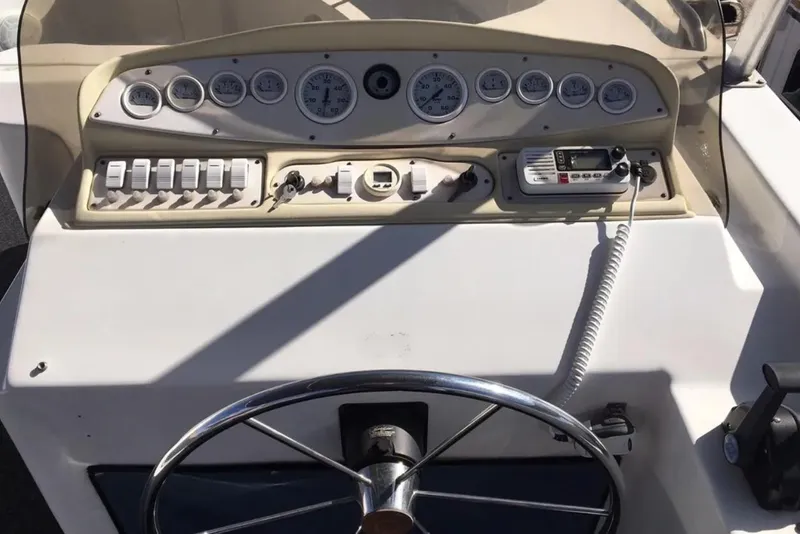 Slide: The Image of Control panel of a 2005 Sumerset Star Chaser boat, featuring gauges and a steering wheel. - 18