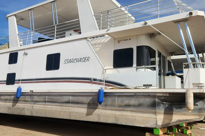 The Image of 2010 Destination Yachts Starchaser Share #10 houseboat docked with blue fenders. - 0