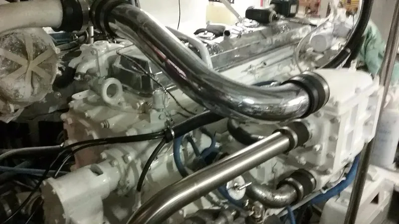 Slide: The Image of Engine room of a 1990 Hi-Tech motor yacht, showcasing complex machinery and piping. - 5