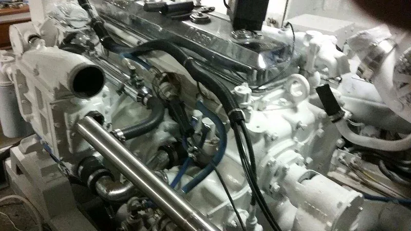 Slide: The Image of Engine of a 1990 Hi-Tech motor yacht, showcasing intricate mechanical components and piping. - 6