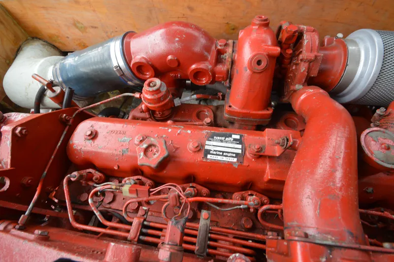 Slide: The Image of Red JC 31 engine from 1978, featuring intricate mechanical components and piping. - 11