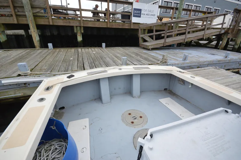 Slide: The Image of 1978 JC 31 boat docked at marina with wooden pier in background. - 20
