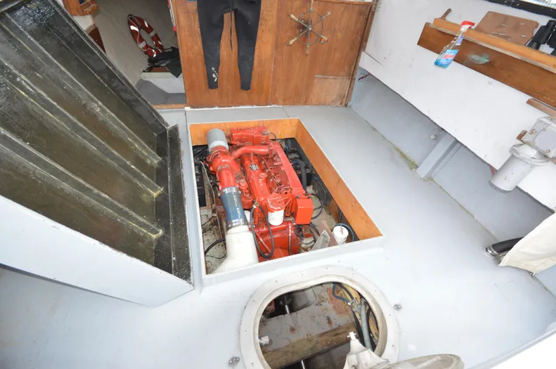 Slide: The Image of 1978 JC 31 boat interior showing engine compartment with red engine. - 8