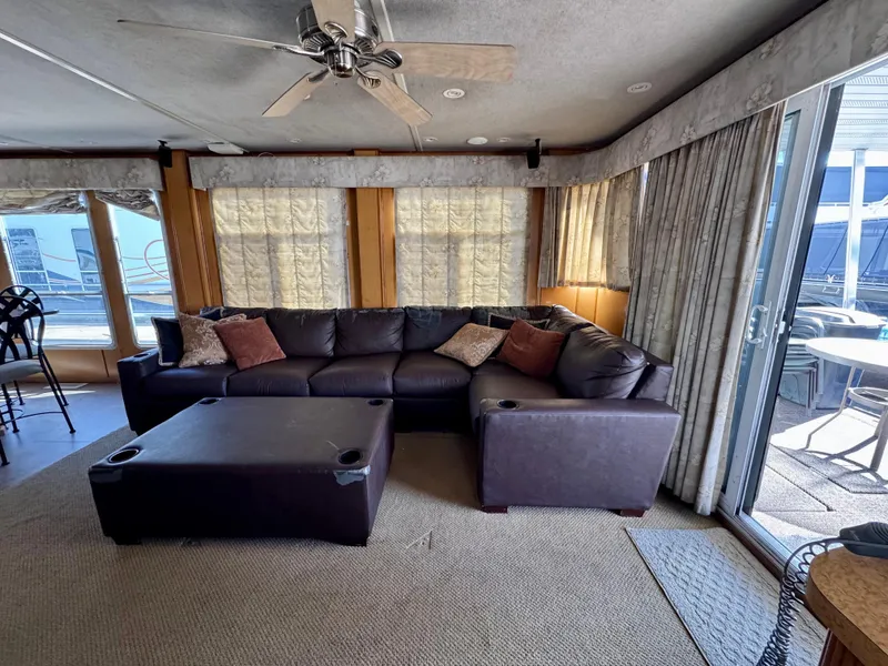 Slide: The Image of Spacious living area in 2003 Sharpe Wailea Trip houseboat with sectional sofa and large windows. - 12