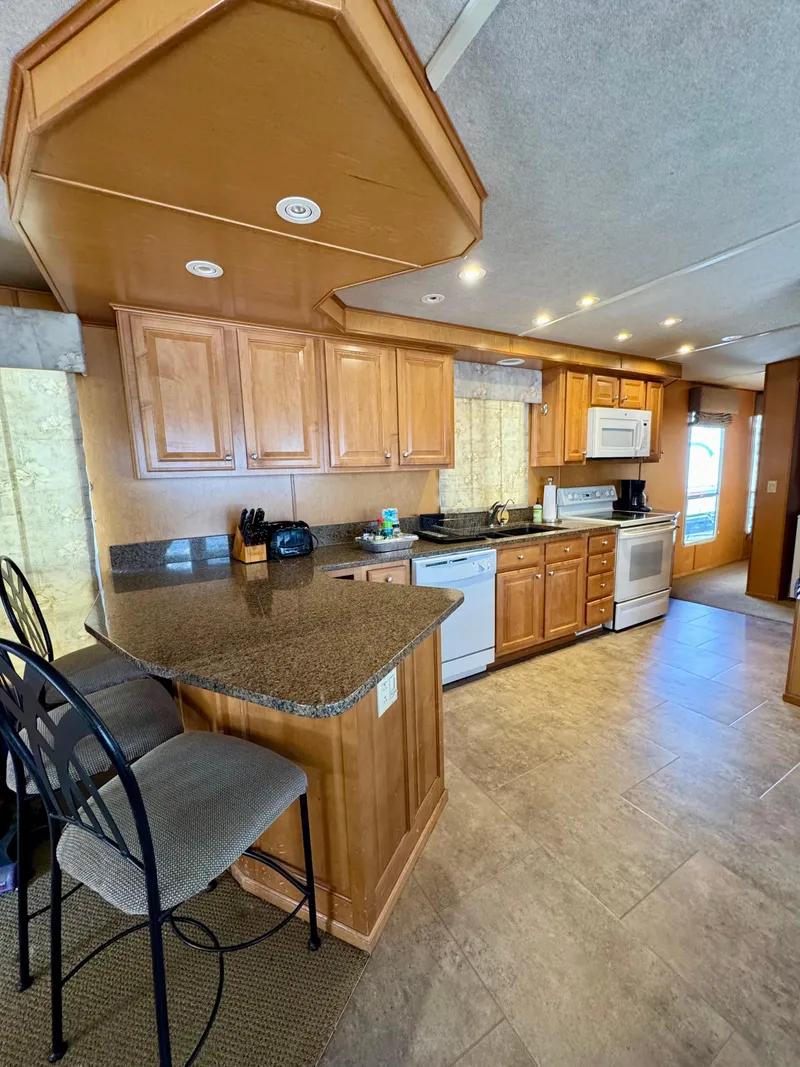 Slide: The Image of Modern kitchen in 2003 Sharpe Wailea Trip houseboat with wooden cabinets and appliances. - 13