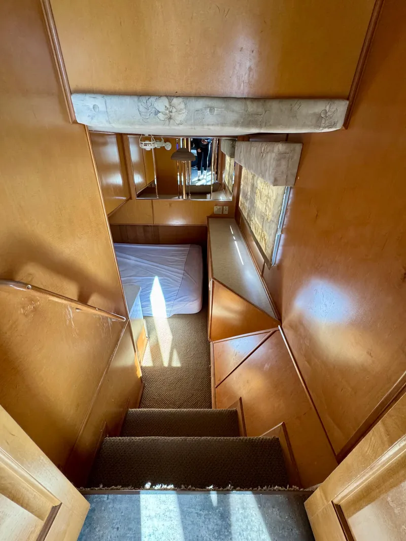 Slide: The Image of Interior of 2003 Sharpe Wailea Trip houseboat, featuring wooden walls and a cozy sleeping area. - 16