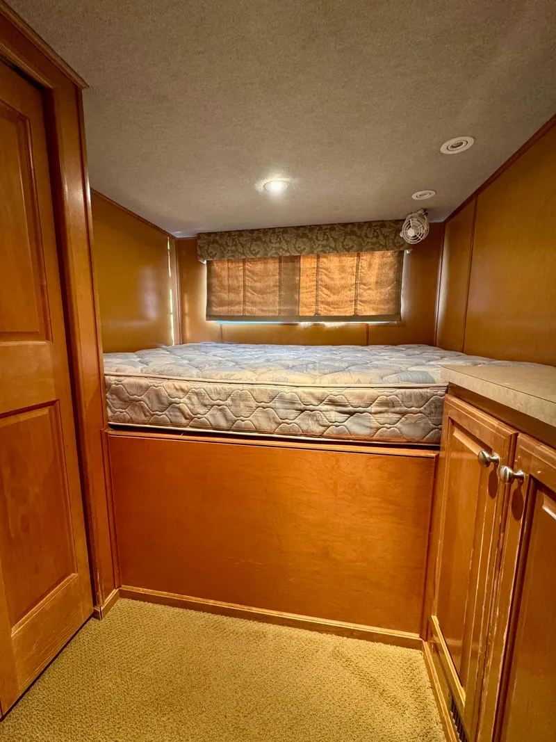 Slide: The Image of Cozy wooden cabin interior with a bed, cabinets, and soft lighting, Sharpe Wailea Trip 2003. - 20