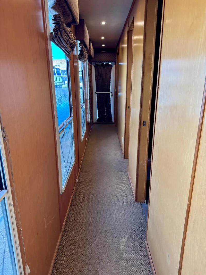 Slide: The Image of Narrow hallway inside 2003 Sharpe Wailea Trip houseboat, featuring wooden walls and carpeted floor. - 21