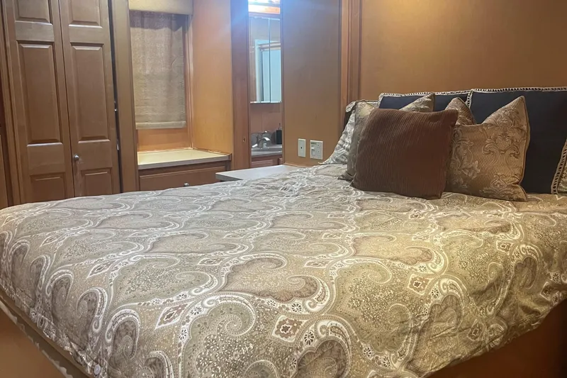 Slide: The Image of Cozy bedroom with patterned bedding in a 2003 Sharpe Wailea Trip model. - 25