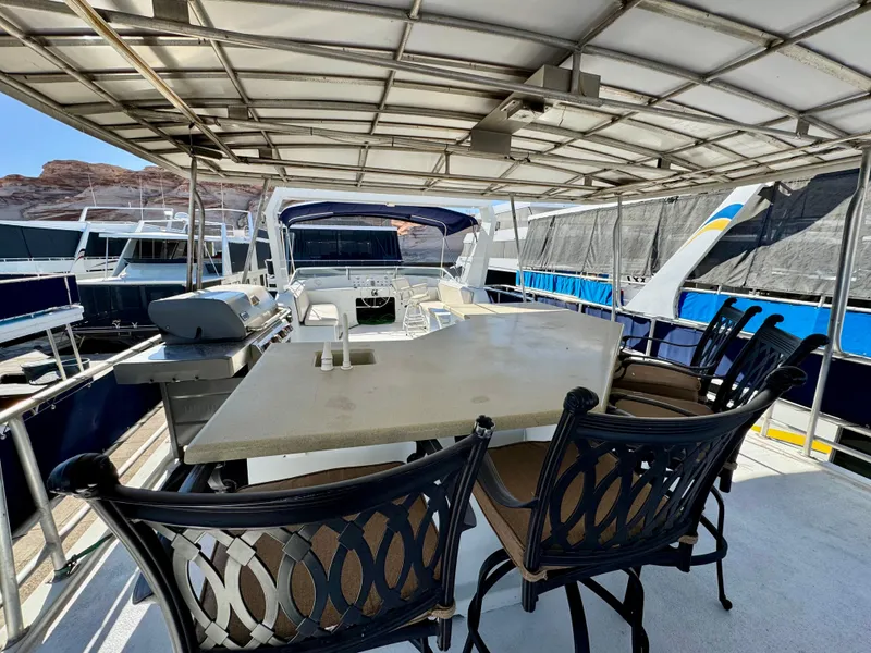 Slide: The Image of Outdoor seating area on a 2003 Sharpe Wailea Trip houseboat with table and chairs. - 33