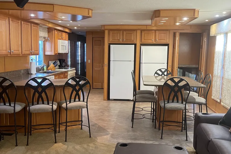 Slide: The Image of Spacious kitchen and dining area in a 2003 Sharpe Wailea Trip houseboat, featuring modern appliances. - 9