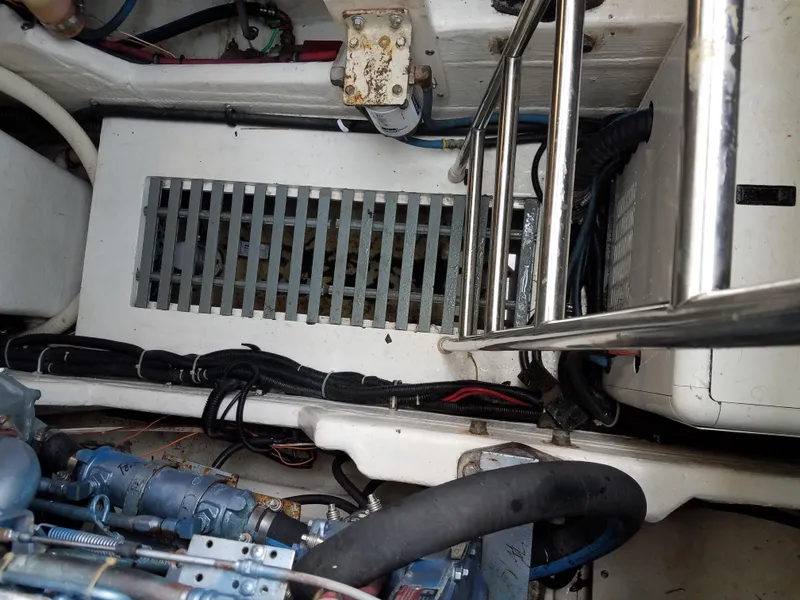 Slide: The Image of Engine compartment of a 1995 Tiara Yachts 3500 Express, showing mechanical components and wiring. - 36