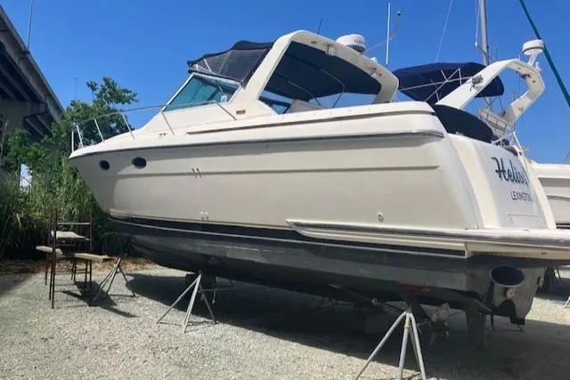 Slide: The Image of 1995 Tiara Yachts 3500 Express boat on stands, outdoor setting, clear sky. - 40