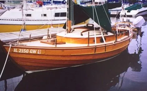 The Image of Wooden sailboat docked, Chip Stulen Faering Design 20, 1987 model, with green canopy. - 0