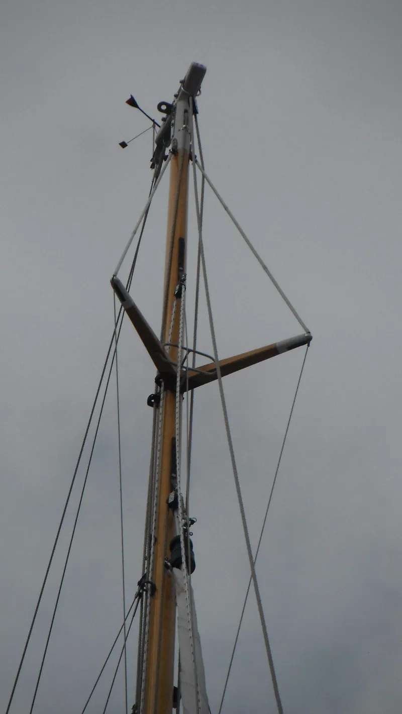 Slide: The Image of Mast of 1987 Chip Stulen Faering Design 20 sailboat against cloudy sky. - 10
