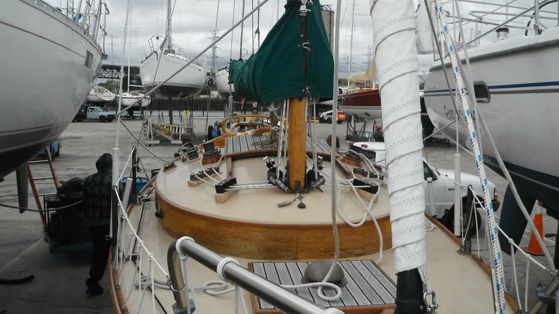 Slide: The Image of Sailboat in dock, Chip Stulen Faering Design 20, 1987 model, with wooden deck and green sail cover. - 13