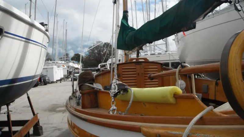Slide: The Image of 1987 Chip Stulen Faering Design 20 sailboat in a marina, surrounded by other boats. - 15