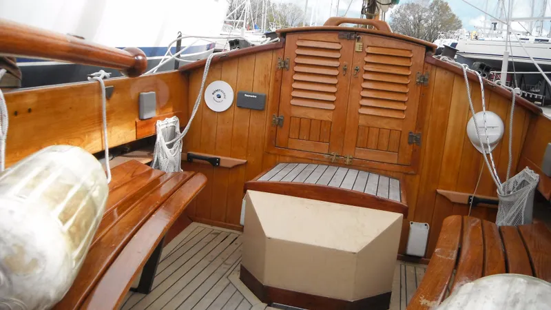 Slide: The Image of Wooden interior of 1987 Chip Stulen Faering Design 20 sailboat, featuring benches and storage compartments. - 17