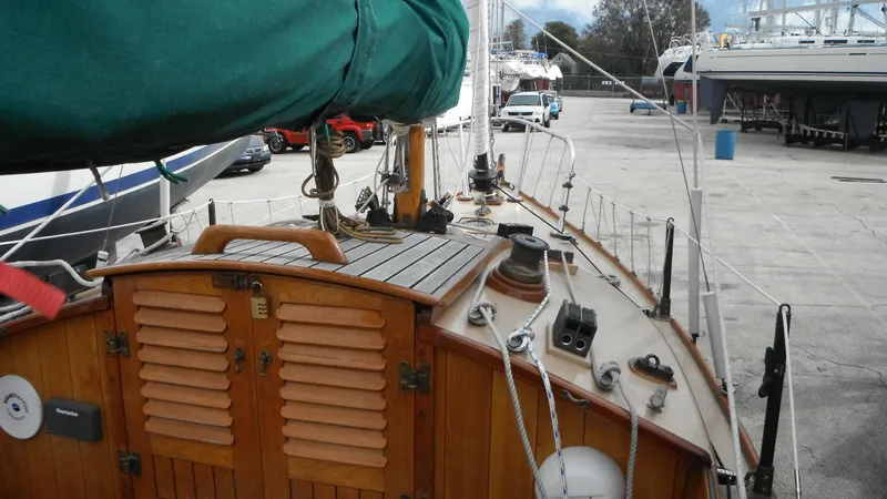 Slide: The Image of Wooden deck of a 1987 Chip Stulen Faering Design 20 sailboat in a marina. - 18