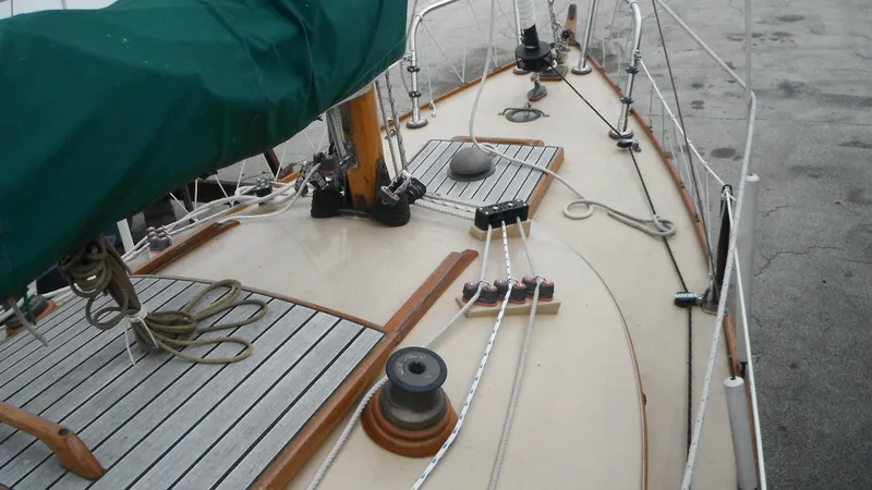 Slide: The Image of Deck view of a 1987 Chip Stulen Faering Design 20 sailboat with rigging and wooden details. - 20