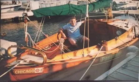 Slide: The Image of A person sitting in a 1987 Chip Stulen Faering Design 20 boat docked at a marina. - 3