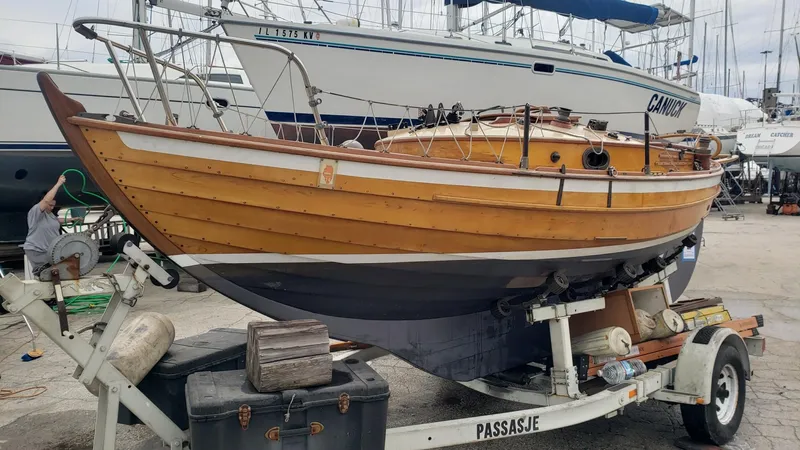 Slide: The Image of Wooden Chip Stulen Faering Design 20 boat from 1987 on a trailer in a marina. - 7