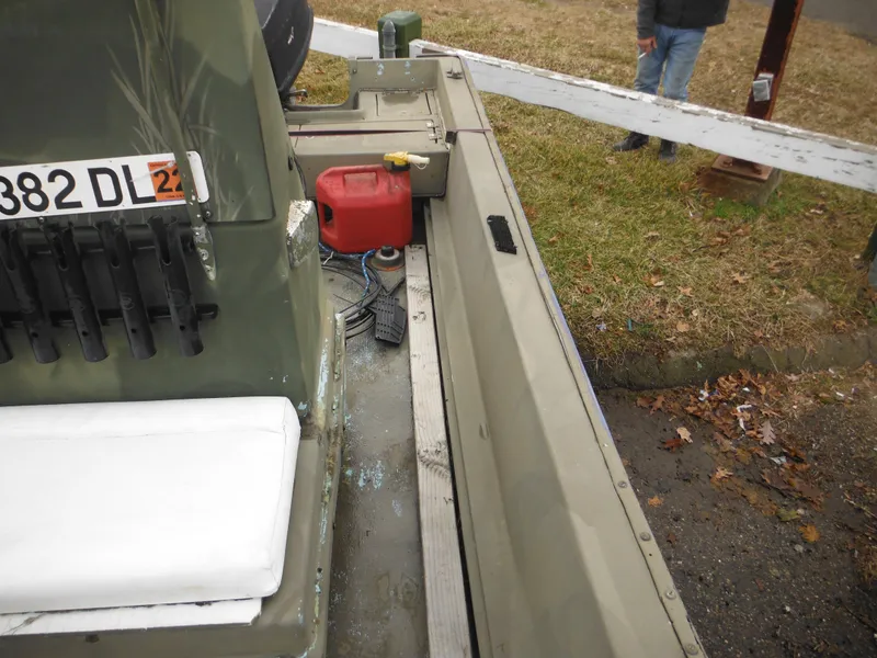 Slide: The Image of 1977 McKee Craft 17S boat interior with fuel tank and seating. - 15