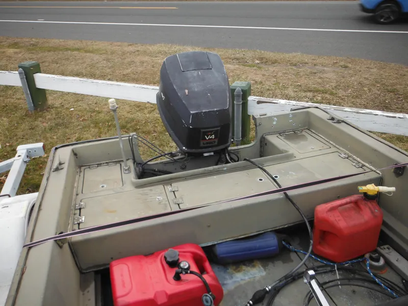 Slide: The Image of 1977 McKee Craft 17S boat with outboard motor and fuel tanks. - 16