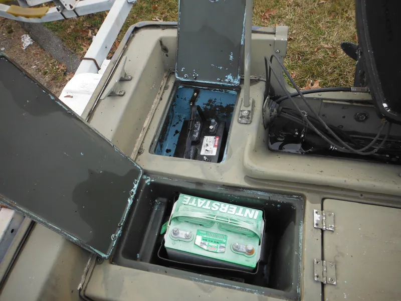 Slide: The Image of 1977 McKee Craft 17S boat battery compartments with Interstate battery. - 18