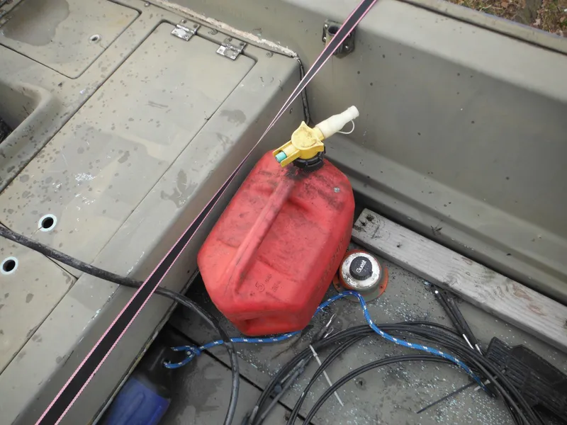 Slide: The Image of 1977 McKee Craft 17S boat interior with red fuel tank and wiring. - 23