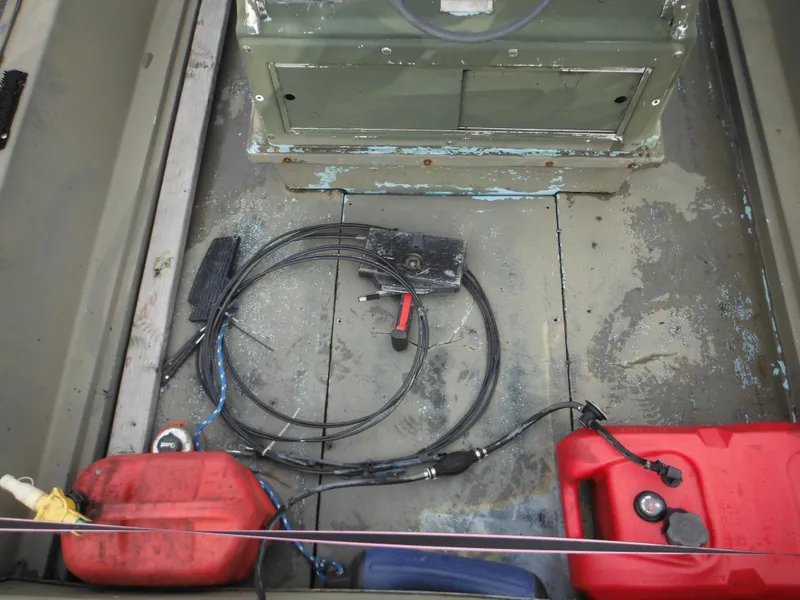 Slide: The Image of 1977 McKee Craft 17S boat interior with fuel tanks and wiring. - 24