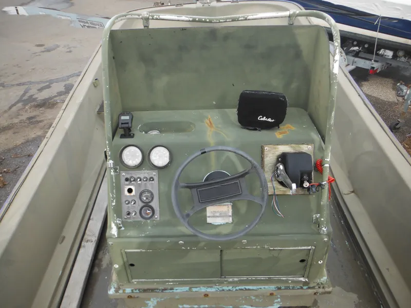 Slide: The Image of 1977 McKee Craft 17S boat console with steering wheel and gauges. - 25
