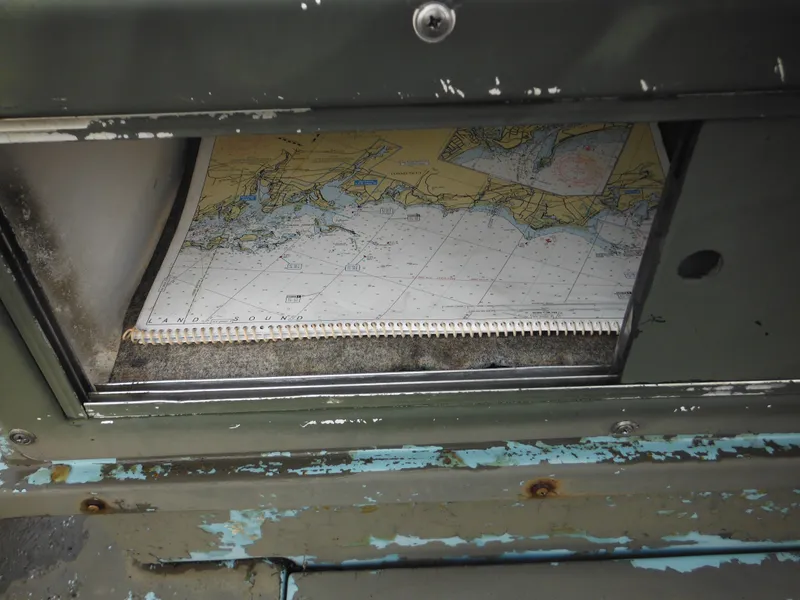 Slide: The Image of Nautical chart stored in a 1977 McKee Craft 17S boat compartment. - 27