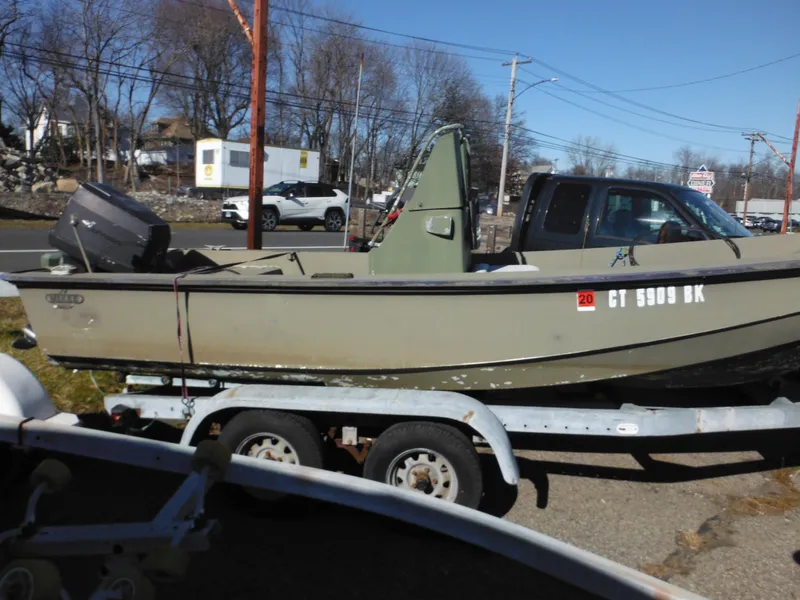 Slide: The Image of 1977 McKee Craft 17S boat on trailer, side view, parked outdoors. - 3