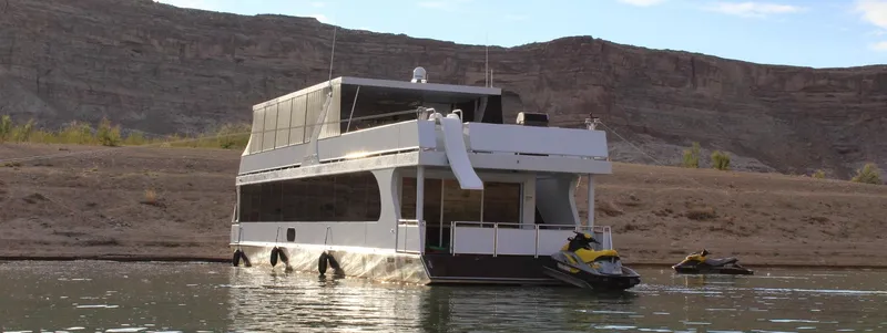 The Image of 2015 Bravada Evolution Share #7 houseboat with slide and jet skis on a lake. - 0