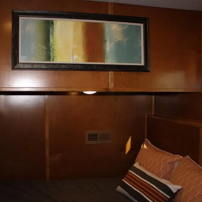 Slide: The Image of 2015 Bravada Evolution Share #7 interior with modern art and cozy bedding. - 10