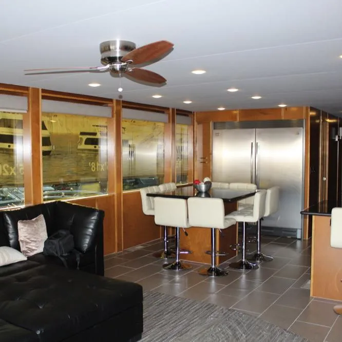 Slide: The Image of Modern interior of 2015 Bravada Evolution Share #7 houseboat with dining area and stainless steel appliances. - 7