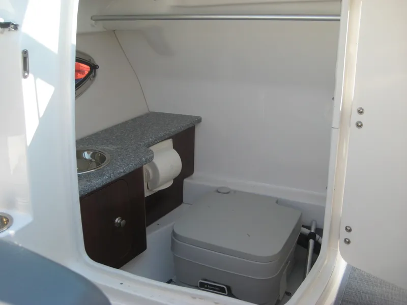 Slide: The Image of 2015 Chaparral 244 Sunesta boat interior with compact bathroom amenities. - 12
