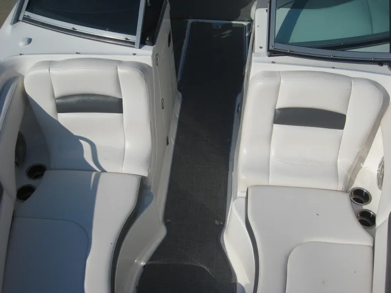 Slide: The Image of 2015 Chaparral 244 Sunesta boat interior with white seating and cup holders. - 14