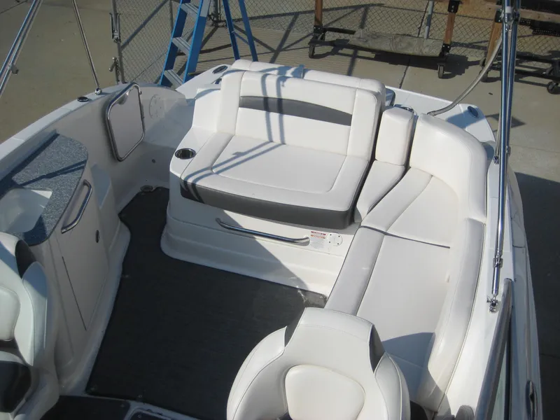 Slide: The Image of 2015 Chaparral 244 Sunesta boat interior with white seating and cup holder. - 15