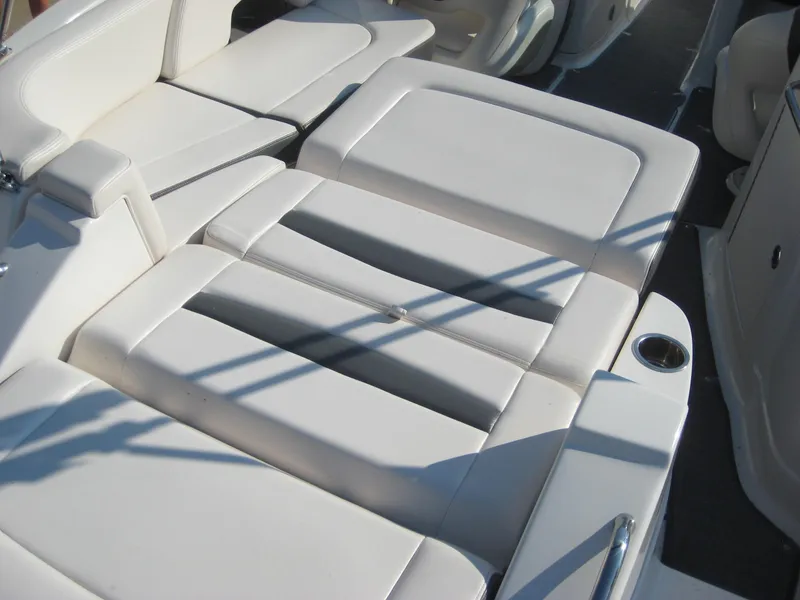 Slide: The Image of 2015 Chaparral 244 Sunesta boat interior with white cushioned seating. - 17