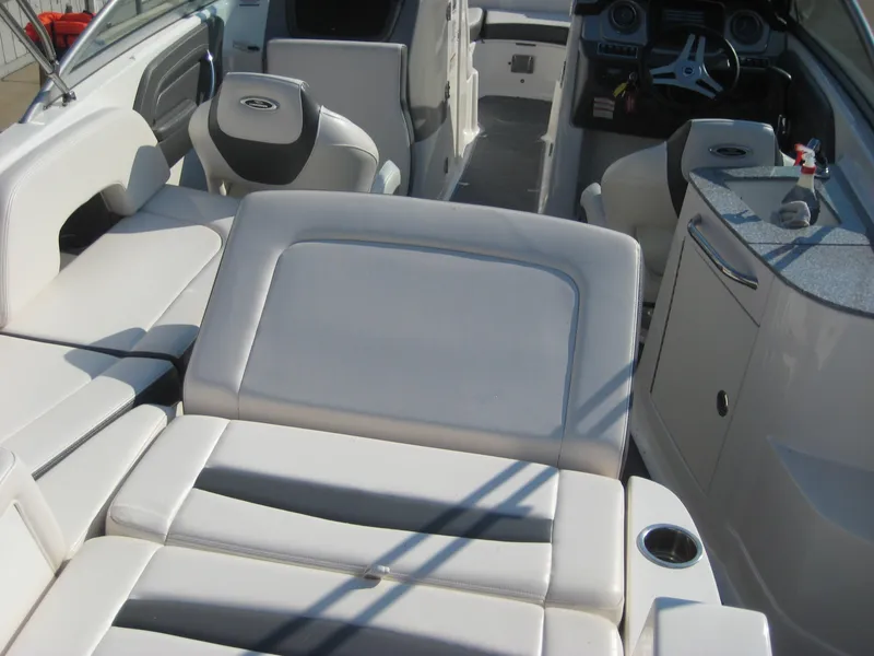 Slide: The Image of 2015 Chaparral 244 Sunesta boat interior with white seating and modern dashboard. - 18