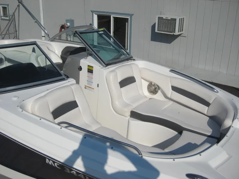 Slide: The Image of 2015 Chaparral 244 Sunesta boat interior with white and gray seating. - 6