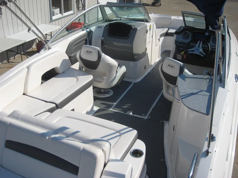 Slide: The Image of 2015 Chaparral 244 Sunesta boat interior with white seating and modern dashboard. - 9