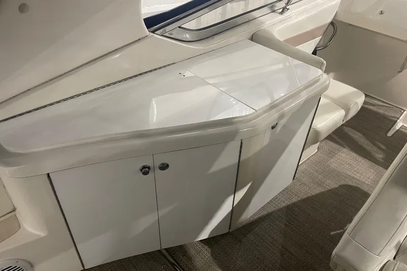 Slide: The Image of 2002 Fountain 38 Express Cruiser interior with white cabinetry and seating. - 10