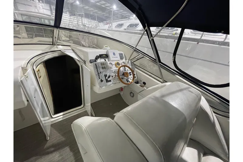 Slide: The Image of 2002 Fountain 38 Express Cruiser cockpit with steering wheel and control panel. - 12